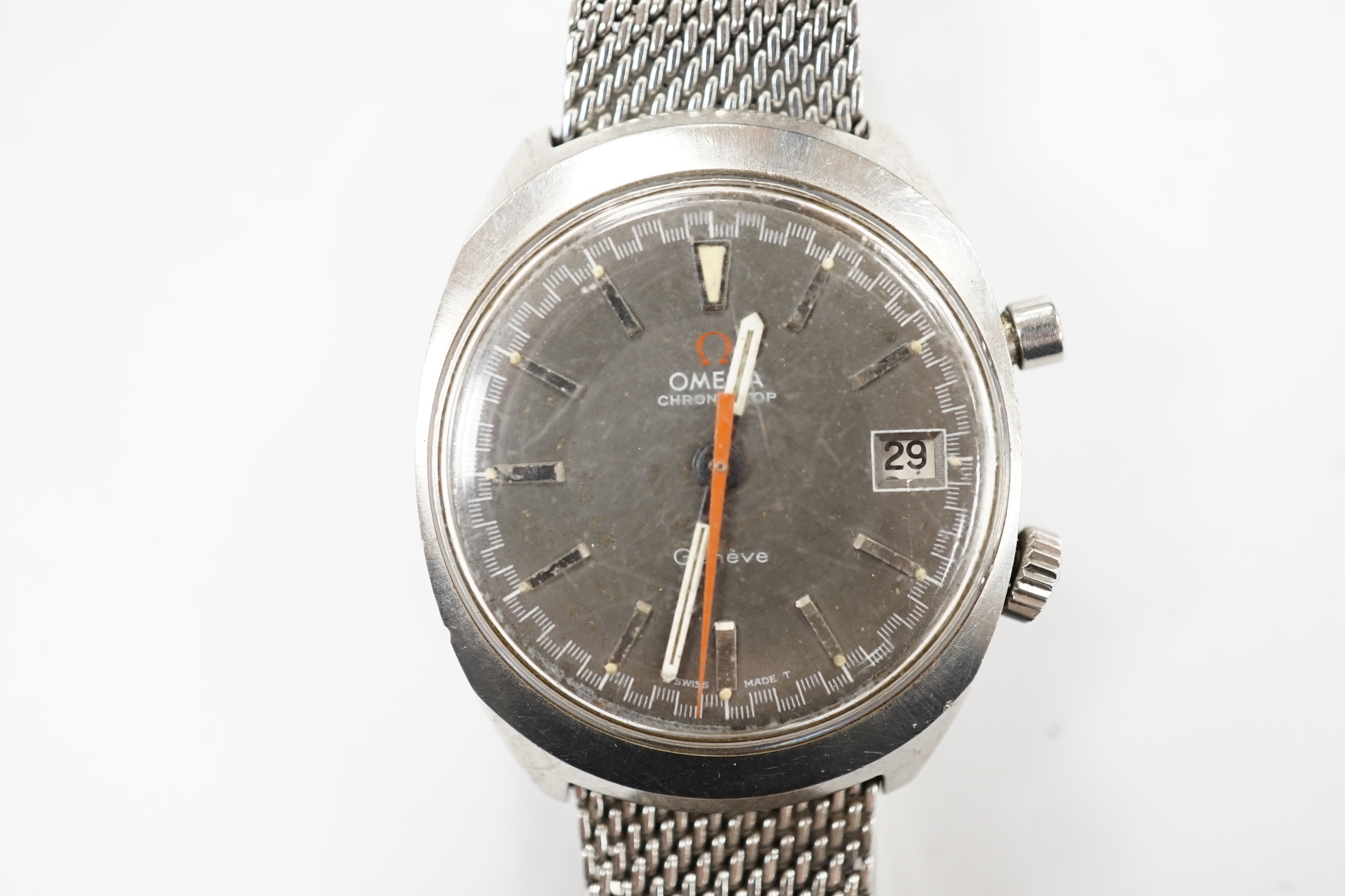 A gentleman's 1970's? stainless steel Omega Chronostop manual wind wrist watch, on a steel Omega mesh link bracelet.